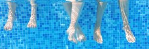 Feet Dipped into Swimming Pool